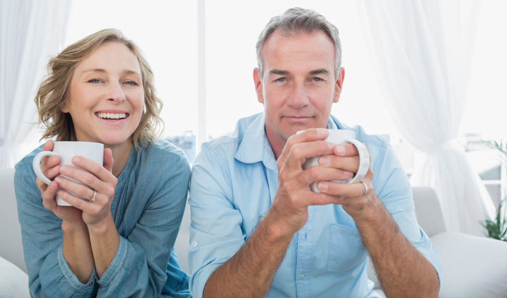 Content middle age couple having coffee in their home, London City Mortgages