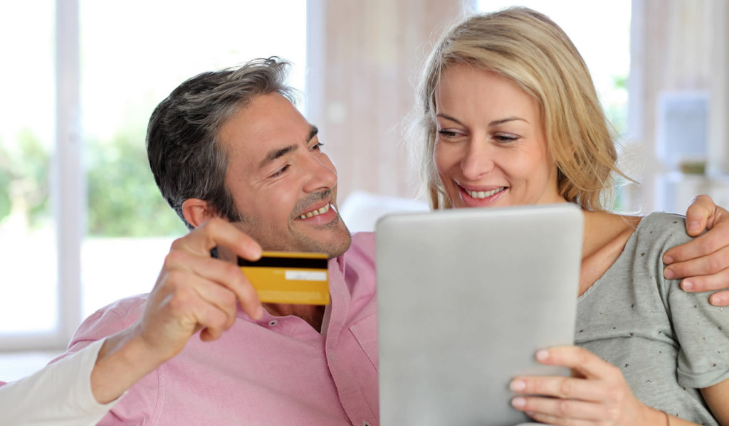 Couple paying for advice and application with their tablet, London City Mortgages