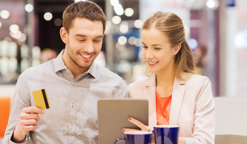 Couple paying for advice service with their tablet, London City Mortgages