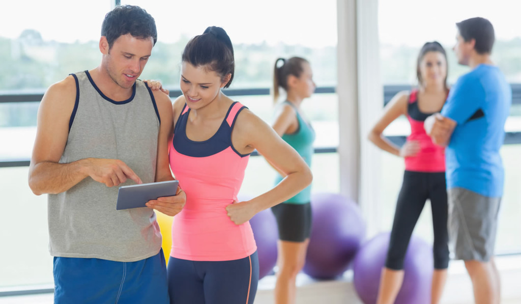 couple-viewing-their-tablet-in-exercise-centre-london-city-mortgages