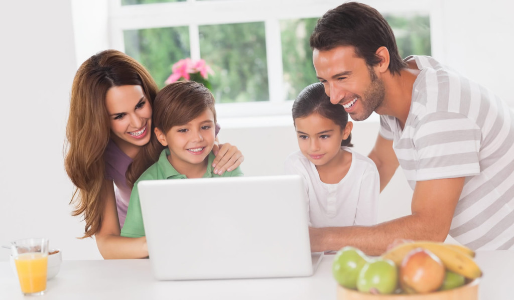 Family at home accessing information on their laptop, London City Mortgages