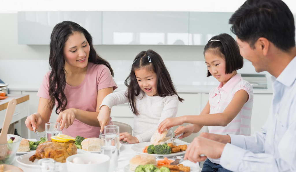 Family enjoying their dinner in their kitchen, London City Mortgages