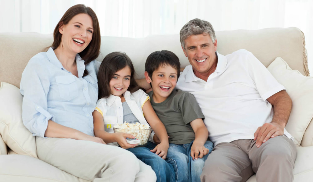 Family watching TV in their livingroom, London City Mortgages