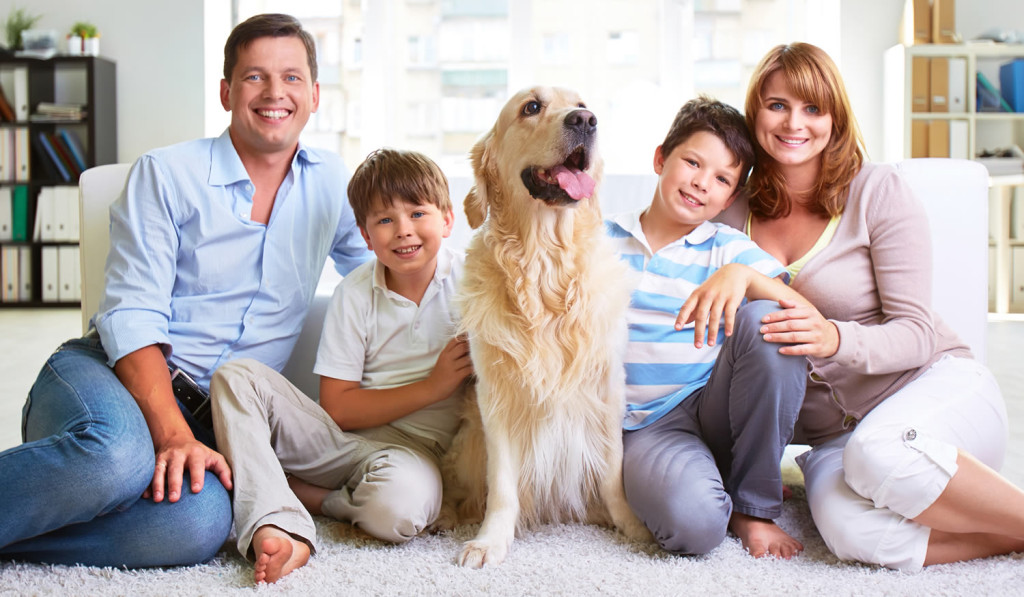 Family of four and their labrador in the lounge, London City Mortgages