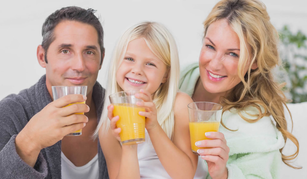 Family drinking orange juice at breakfast, London City Mortgages