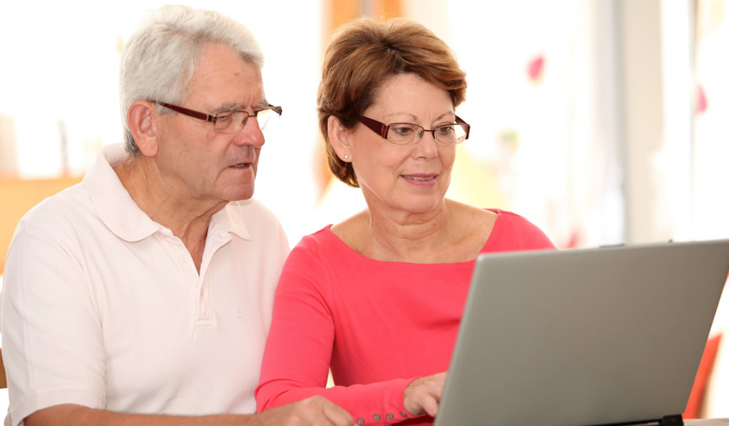 Senior couple receiving thier laptop notices, London City Mortgages