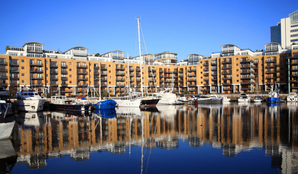 Yachts moored by exclusive homes in St Katherines Dock, London City Mortgages