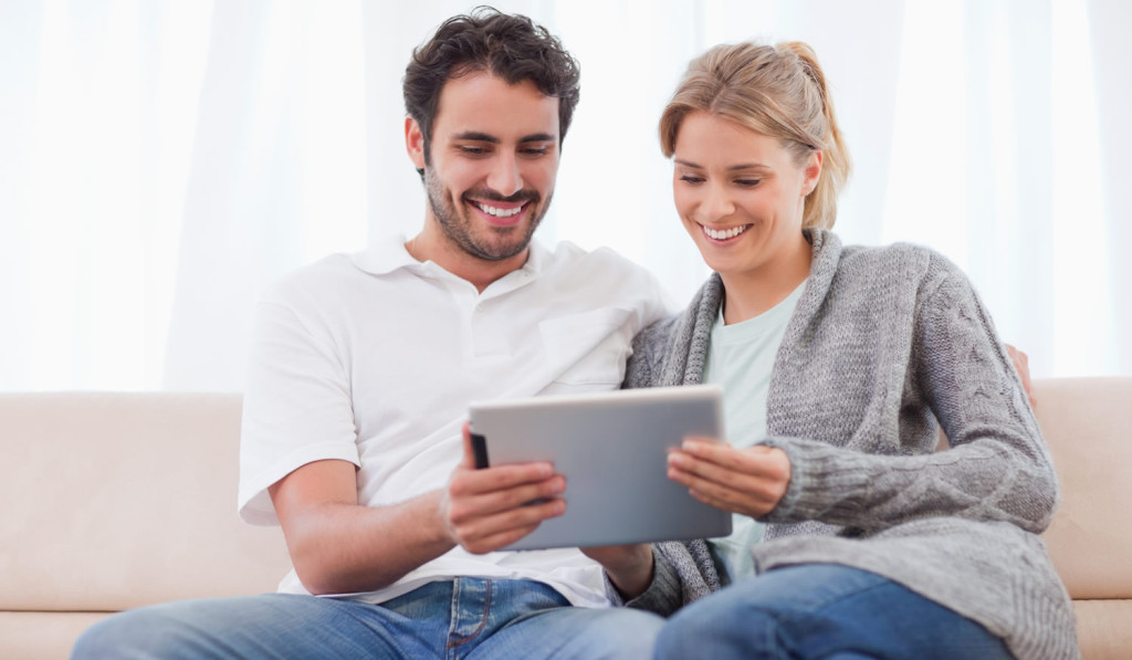 House livingroom couple using tablet London City Mortgages