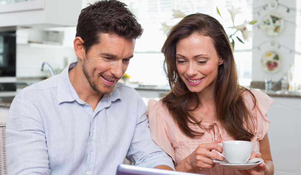 Kitchen with couple checking laptop news London City Mortgages