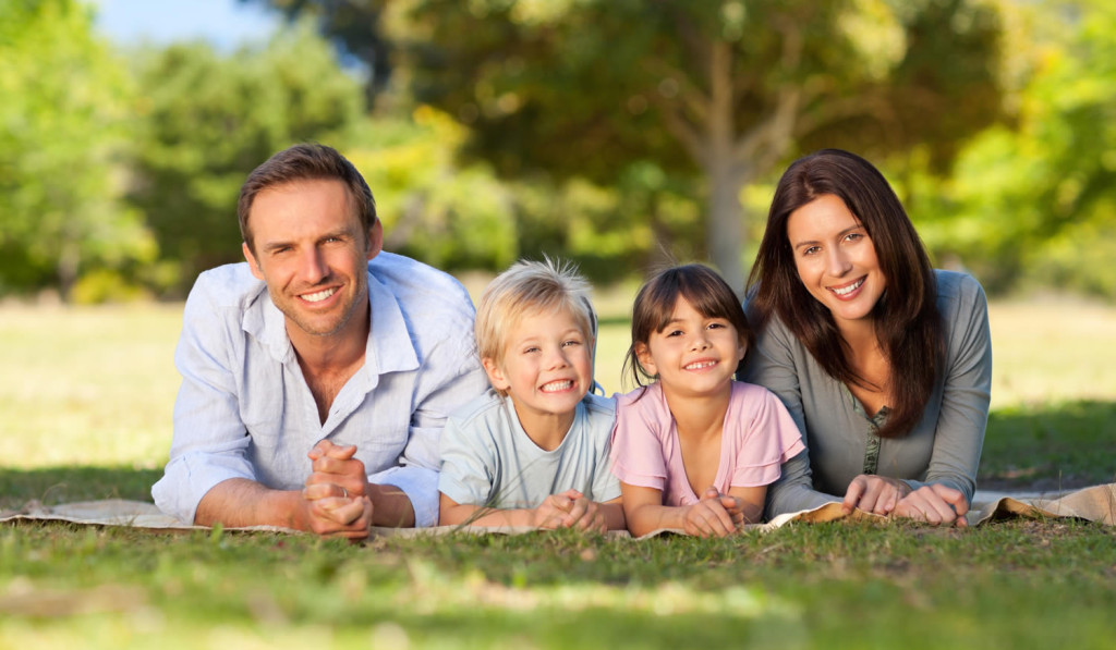 Sunny outdoor park with smiling family London City Mortgages