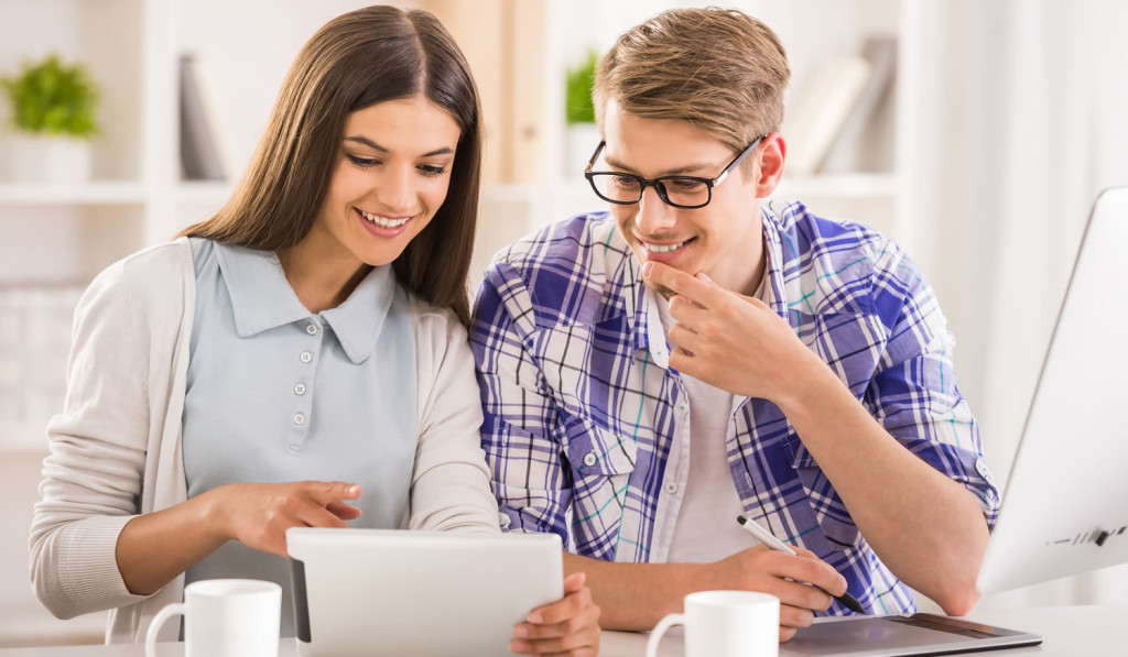 Young couple receiving tablet updates London City Mortgages